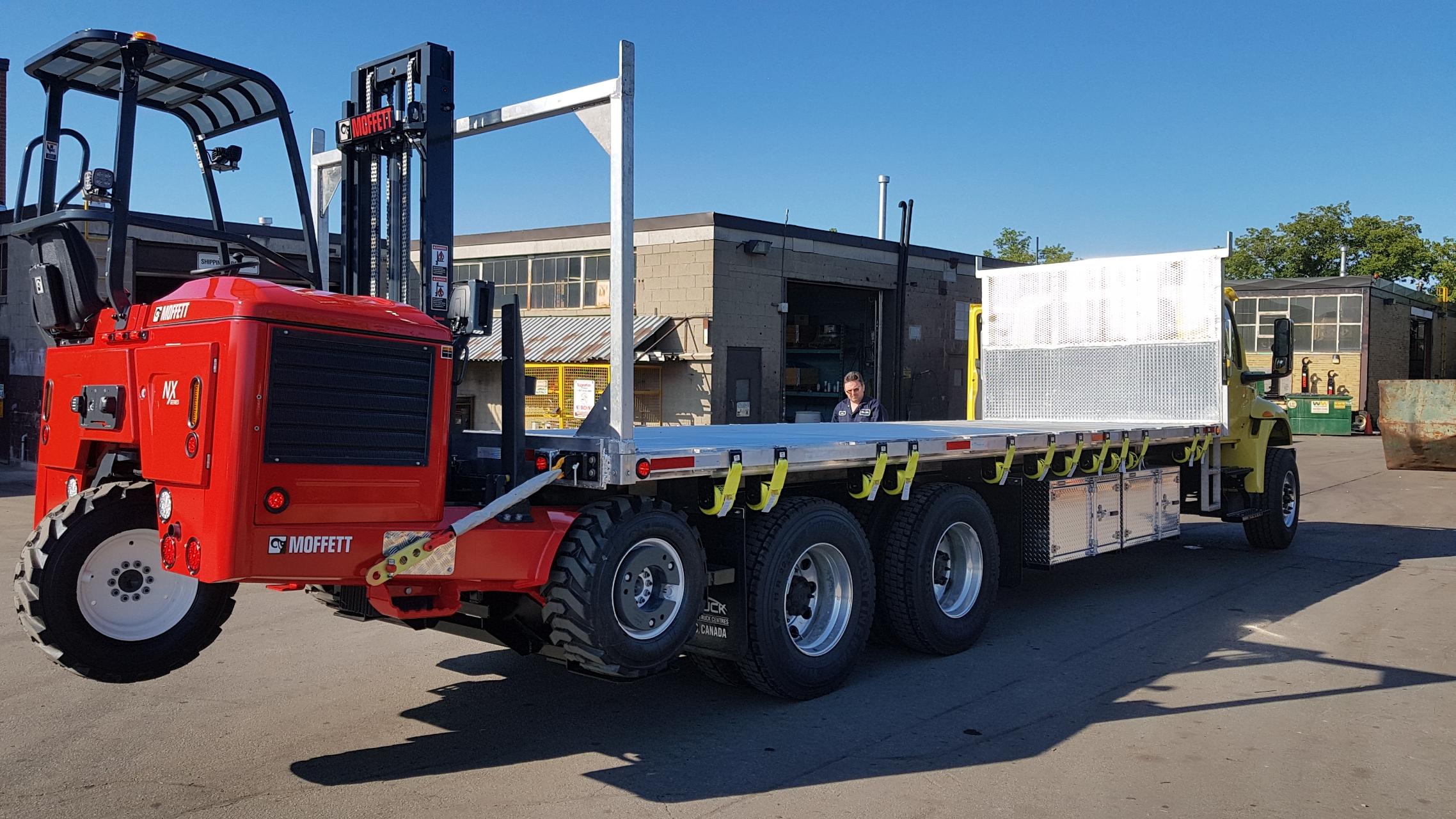 Moffett M8 NX forklift mounted on a flatbed truck, delivered by Trinity Truck Sales