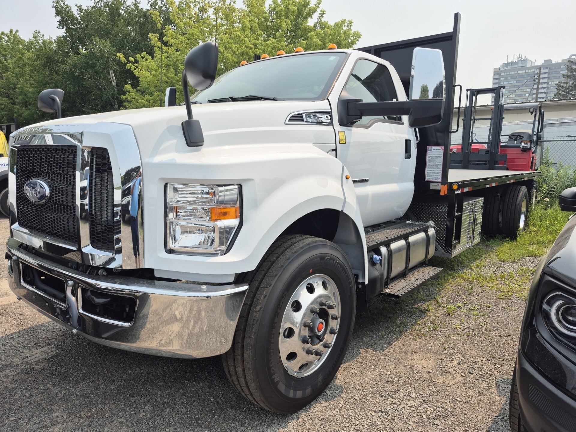 Ford F750 Moffett truck with mounted forklift, delivered by Trinity Truck Sales